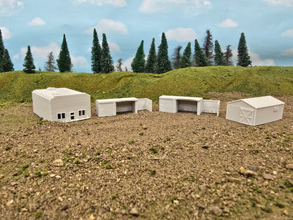 Model buildings on a landscape with trees and sky in the background