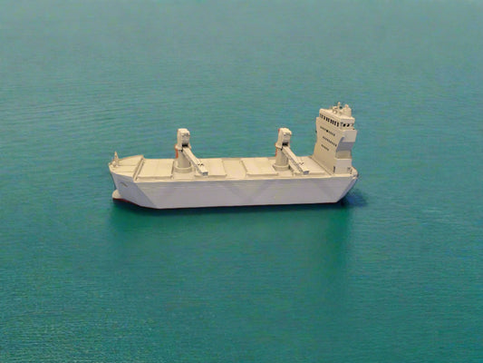 Model ship on a blue surface with a scenic background