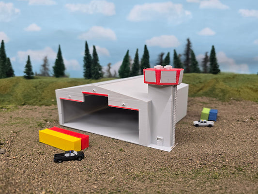 Model of a tunnel entrance with vehicles and trees in the background