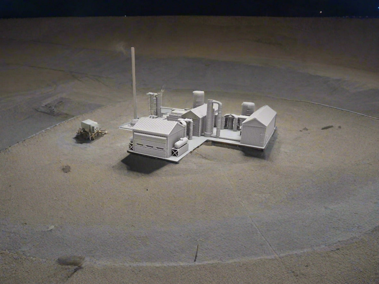 Small model of a factory layout on a white surface 