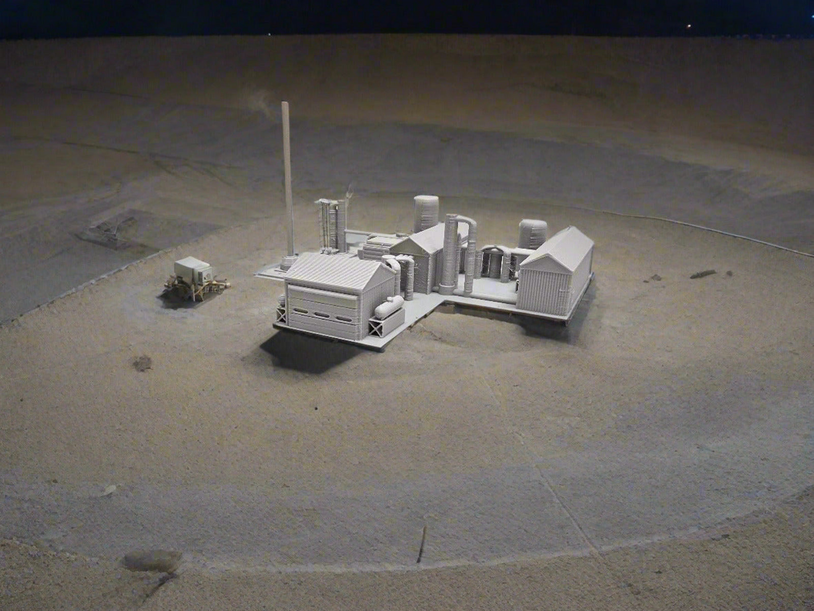 Small model of a factory layout on a white surface 